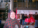 Joe, with American and Austrian flags in the background