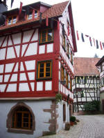 Decorative half-timbered construction and quoins (prominent stones at wall corners or door and window openings) of the J�gerh�usle, built into the city wall of this perfectly preserved town in the Kinzig Valley surrounded by sunny forested slopes & shady valleys.